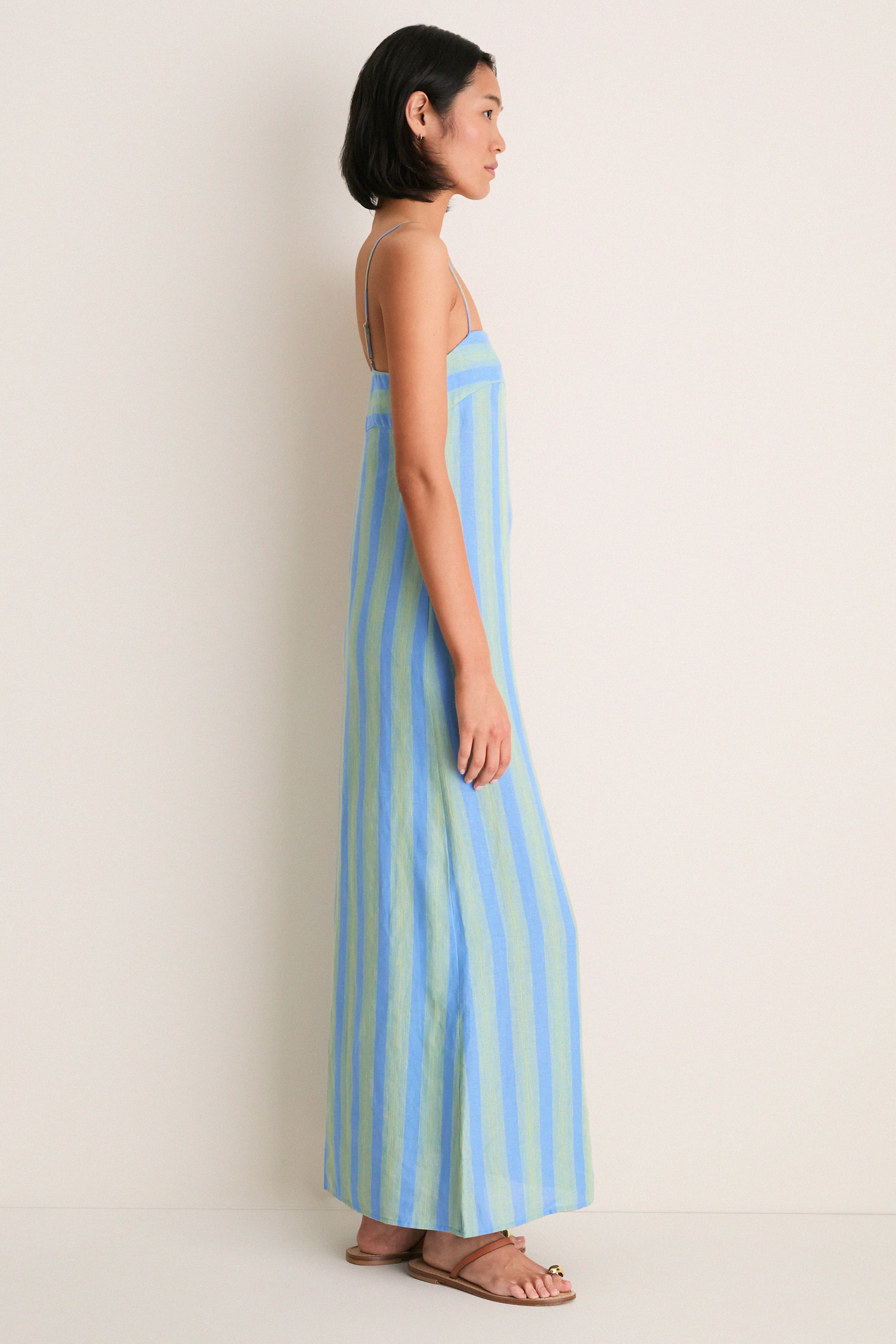 Seaport Stripe Laura Linen Dress: A classic, effortless floor-length sundress with pale blue and green stripes, square neckline, and adjustable spaghetti straps for a fun, high-end look.