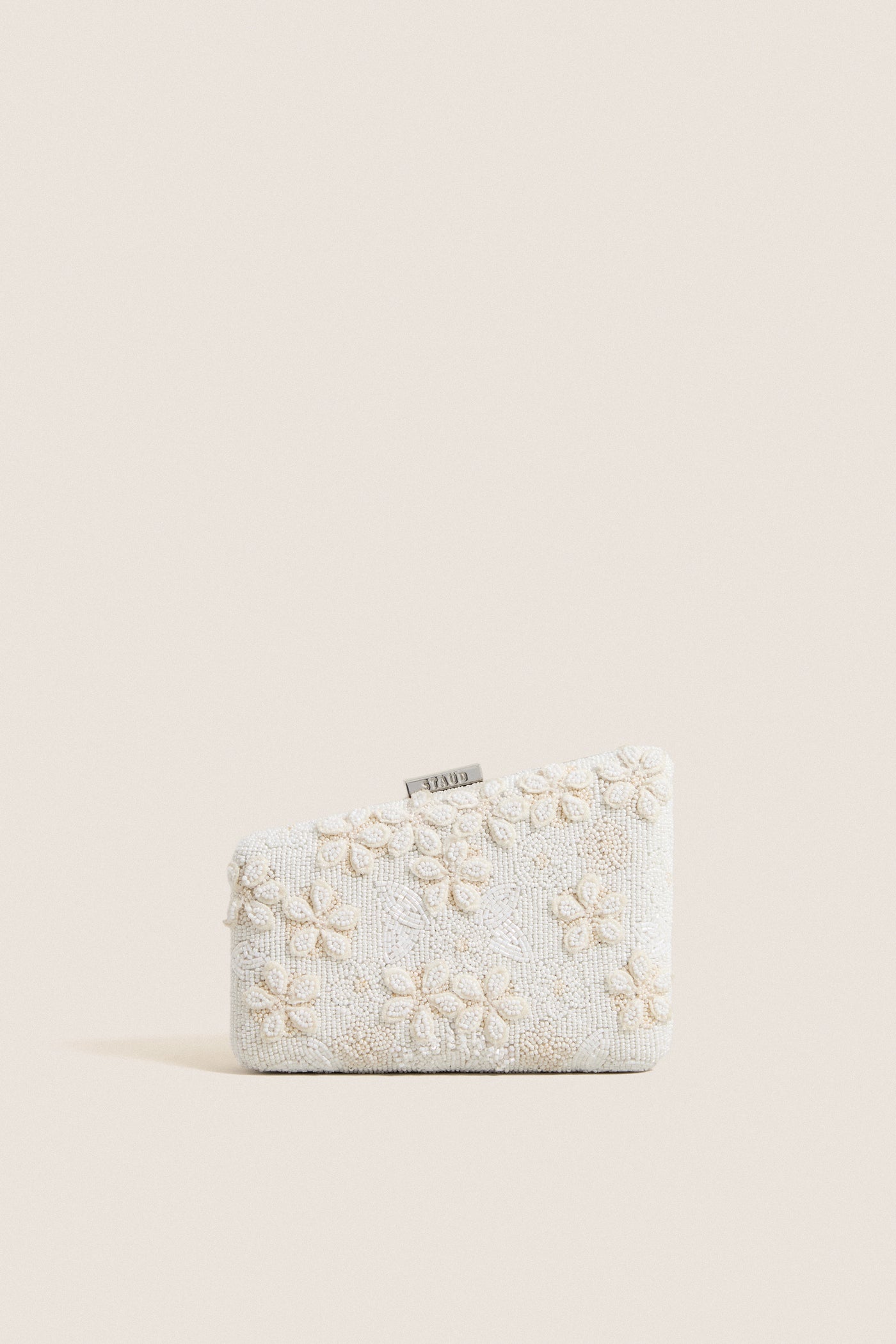Garden Party Carmella Beaded Clutch, showcasing classic, high-end beadwork with floral motifs and effortless design, featuring a playful asymmetrical shape and removable chain strap.