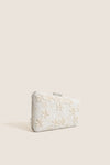 Garden Party Carmella Beaded Clutch with classic off-white floral beadwork, effortless asymmetrical design, and fun removable chain strap, exuding high-end elegance for versatile occasions.