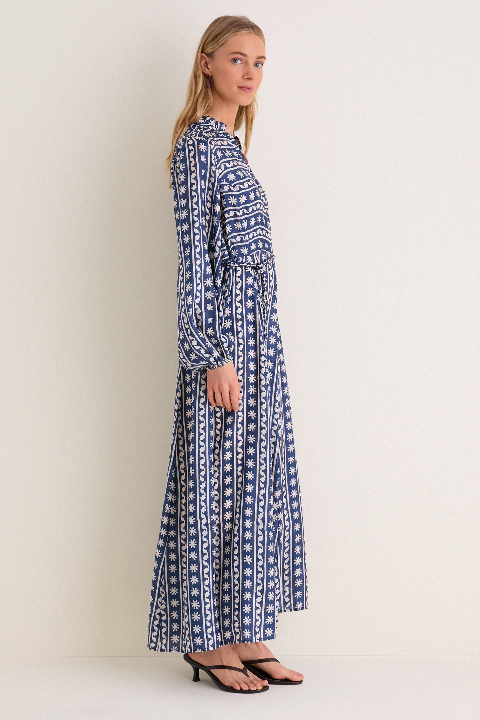 Wave Wonder Nala Maxi Dress: A classic, effortless A-line maxi with a V-neckline and braided belt, exuding high-end elegance and fun sophistication in a floral blue-and-white print.