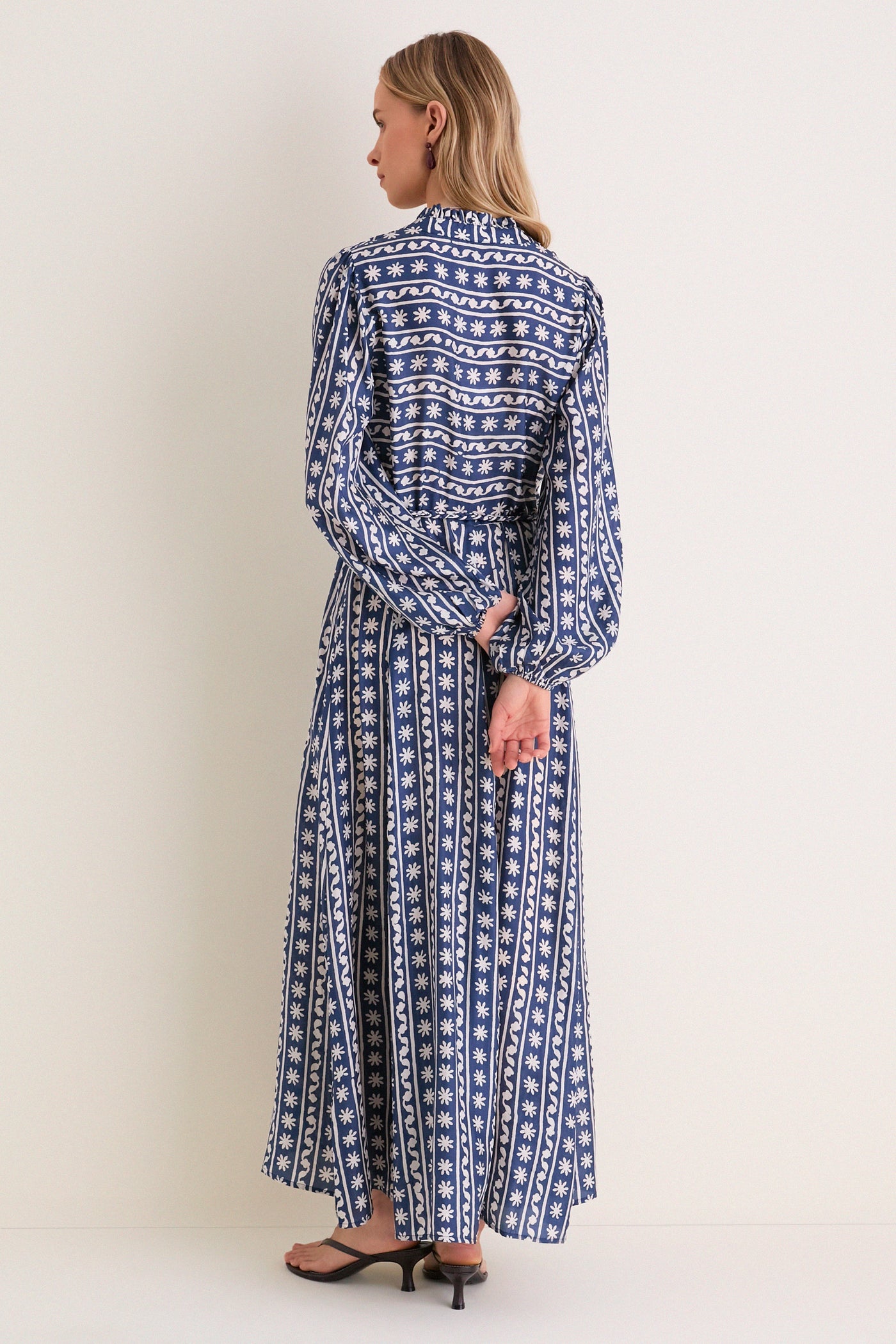 Wave Wonder Nala Maxi Dress, a classic, high-end piece with a flowing A-line silhouette, long sleeves, and hand-braided belt, offering effortless elegance and fun style.
