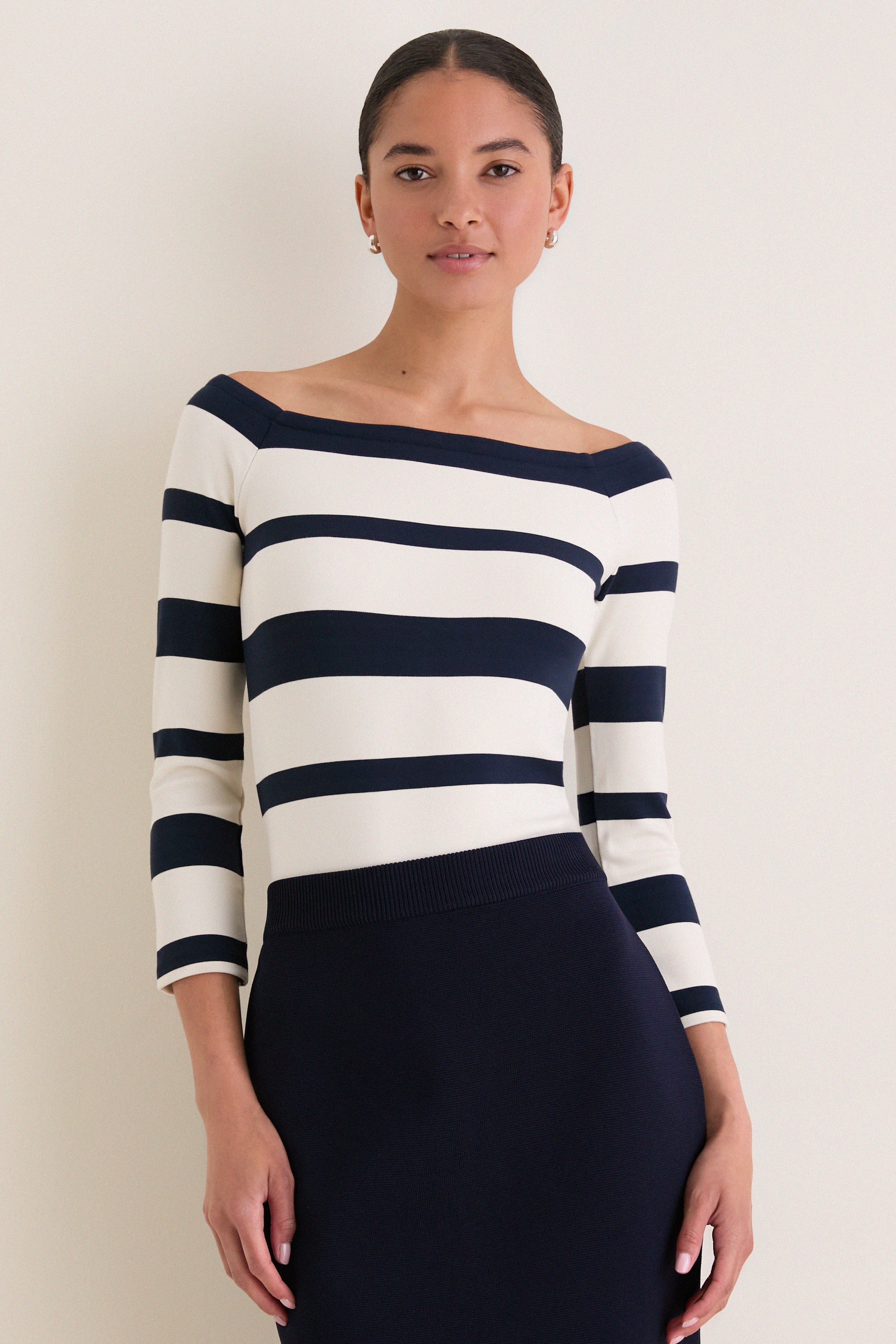 Liberty Stripe Knit Boyers Top on woman, showcasing classic, off-the-shoulder design with variegated stripes, offering an effortless, high-end look perfect for any occasion.