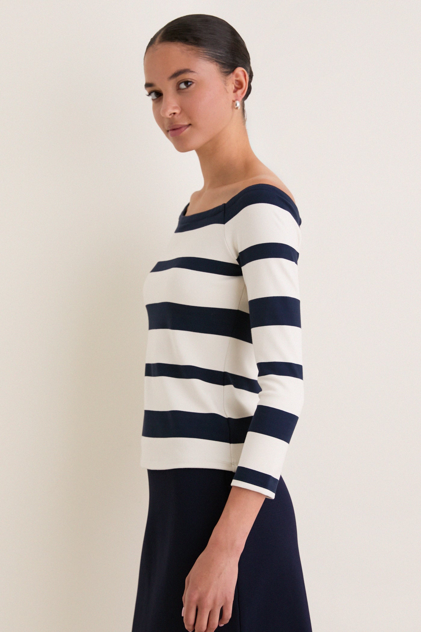 Liberty Stripe Knit Boyers Top, showcasing a classic, effortless style. The fitted off-the-shoulder design with three-quarter sleeves offers a high-end, versatile look for fun, modern wear.