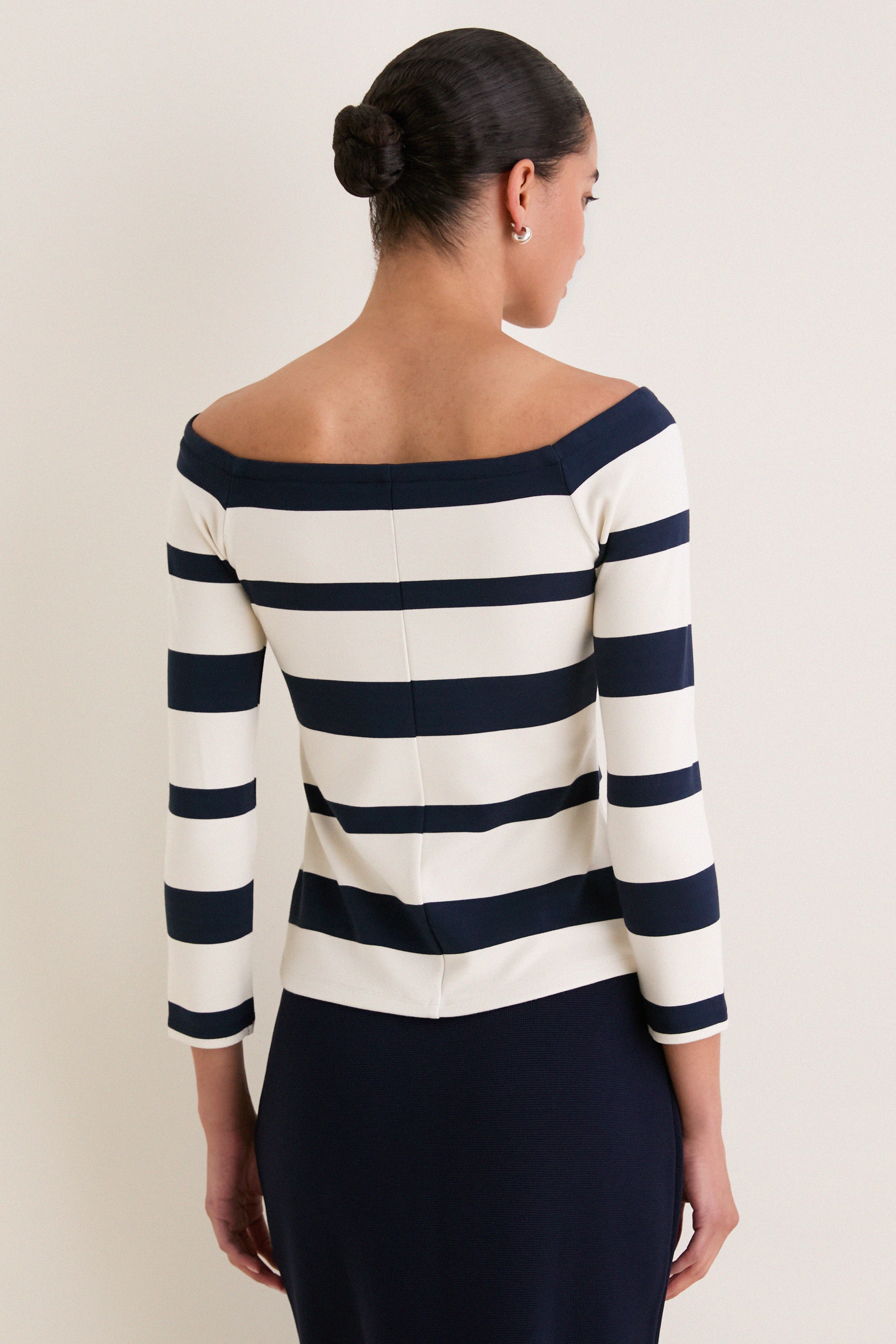Liberty Stripe Knit Boyers Top: Classic off-the-shoulder, striped top with three-quarter sleeves, paired effortlessly with a navy pencil skirt for an elegant, high-end look.