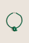 Green Mykonos Necklace: Classic malachite beads with an enamel animal-shaped pendant, silver clasp. Effortless, high-end design for fun, stylish outings.