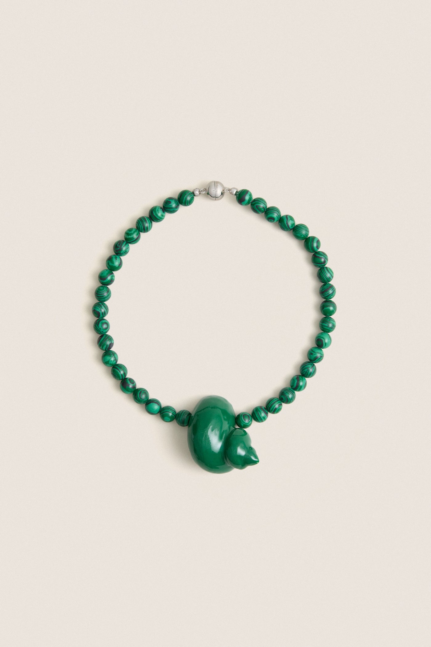 Green Mykonos Necklace: Classic malachite beads with an enamel animal-shaped pendant, silver clasp. Effortless, high-end design for fun, stylish outings.