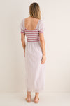 Model wearing the classic Poppy Half Drop White Madeline Nap Dress with a scooped back, flutter sleeves, and smocked bodice, embodying effortless, high-end style.
