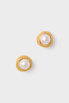 Gold Gigi Earrings featuring classic round faux pearls encased in textured gold-tone borders. Effortless and fun, these high-end earrings exude a vintage-inspired charm.