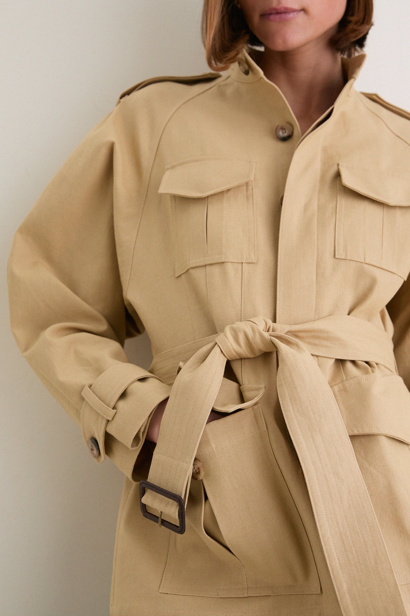 Classic Camel Cotton Field Jacket showcases effortless style with flap pockets, epaulets, and a cinched waist, combining utility and chic high-end tailoring for a fun, polished look.