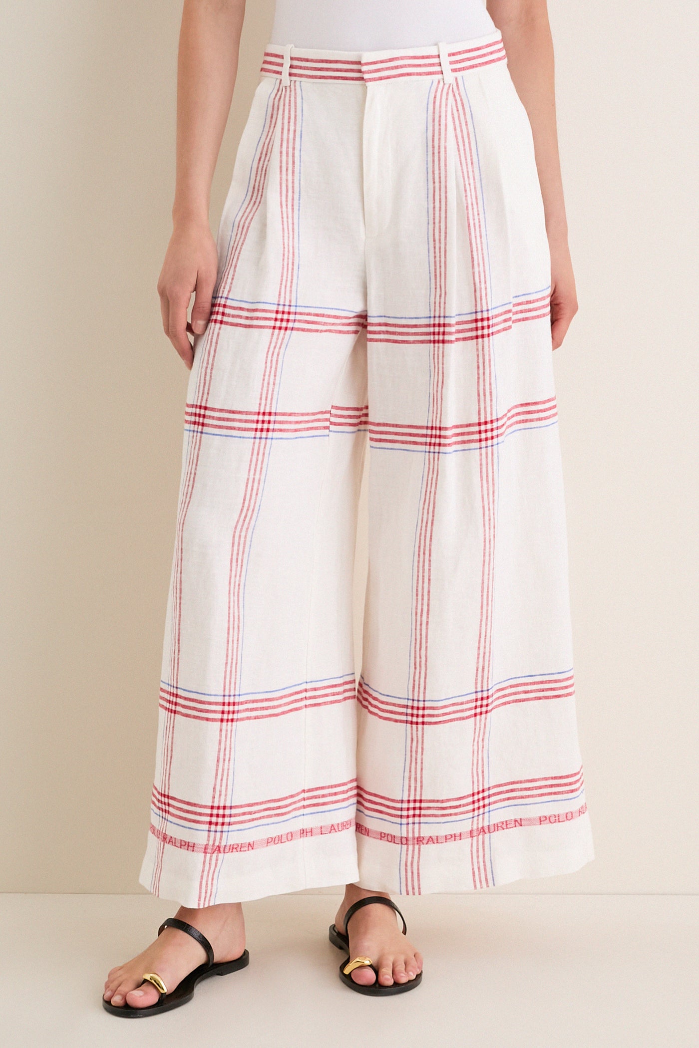 Classic Polo Ralph Lauren wide-leg trousers with a red-and-blue plaid, high-waisted design. Effortless style with pleats and signature hem detail, perfect for fun, high-end wear.
