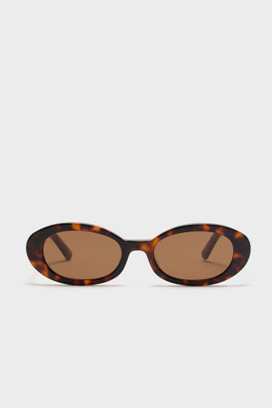 Brown Tortoise Lyric Leigh Sunglasses, featuring classic, effortless oval frames with UV protection, embodying high-end style and fun sophistication.