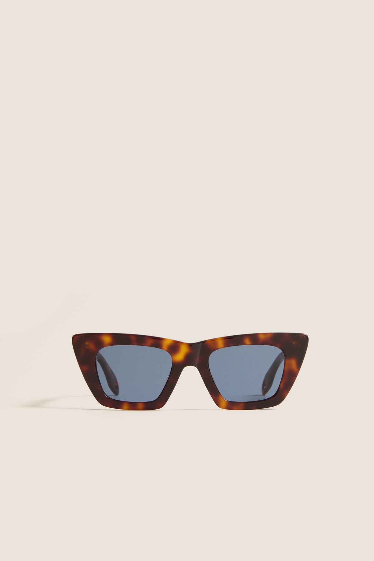 Brown Tortoise Dark Blue Lens Lori Sunglasses, featuring a classic cat-eye shape with a tortoiseshell frame, offer an effortless, high-end touch with a fun, modern twist.