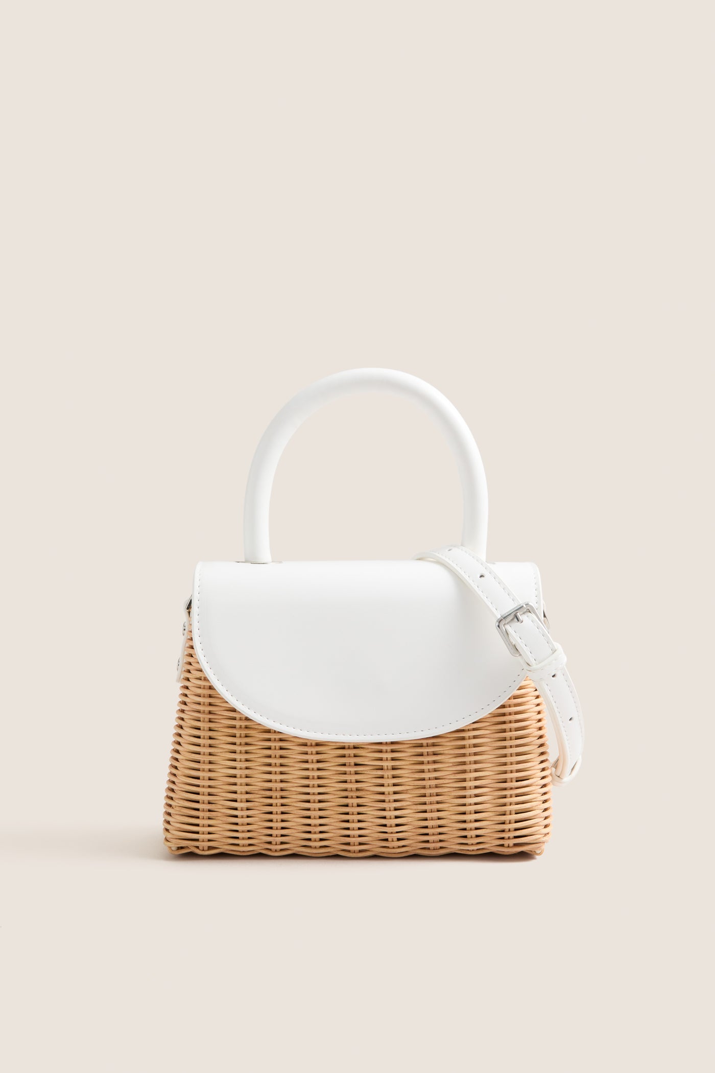 White Elle Wicker Top Handle bag with white vegan leather accents and detachable strap, offering a classic, effortless, high-end style for fun summer occasions.