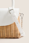 White Elle Wicker Top Handle bag with sleek vegan leather accents and silver details, offering a classic, effortless, and fun style for high-end summer occasions.
