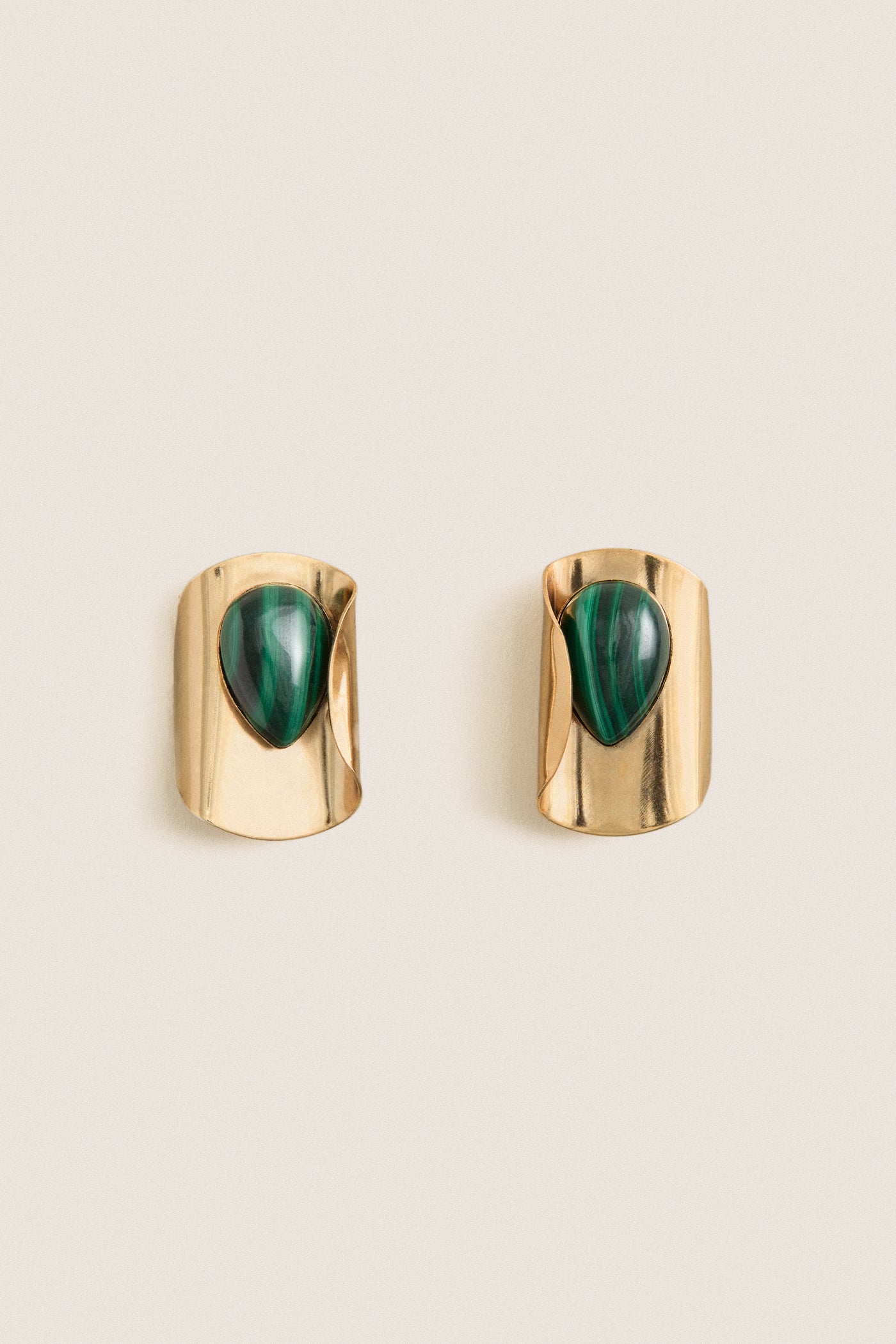 Malachite Keziah Earrings feature classic teardrop malachite stones on gold-plated clips, offering an effortless, high-end touch to elevate any look.