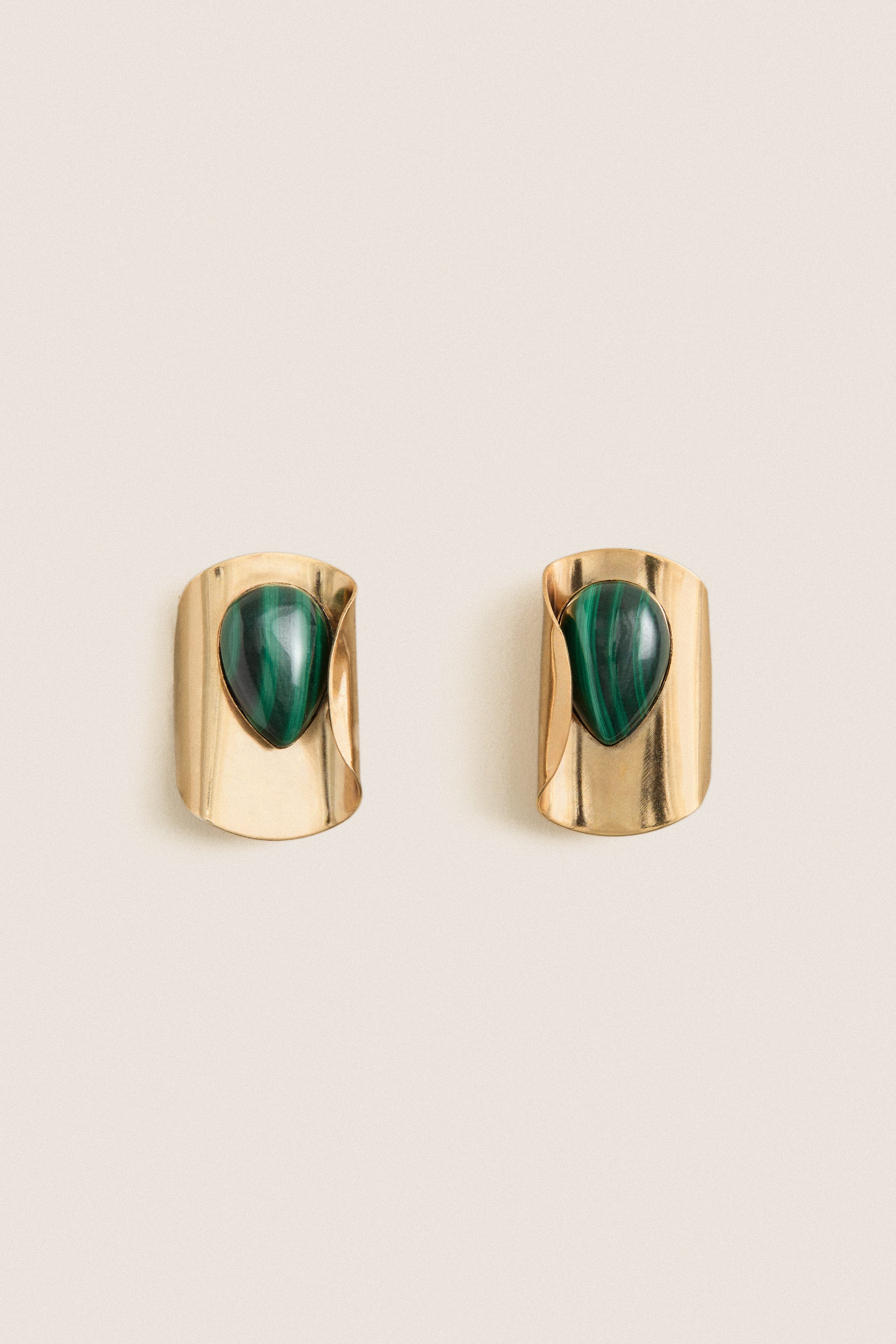 Malachite Keziah Earrings feature classic teardrop malachite stones on gold-plated clips, offering an effortless, high-end touch to elevate any look.