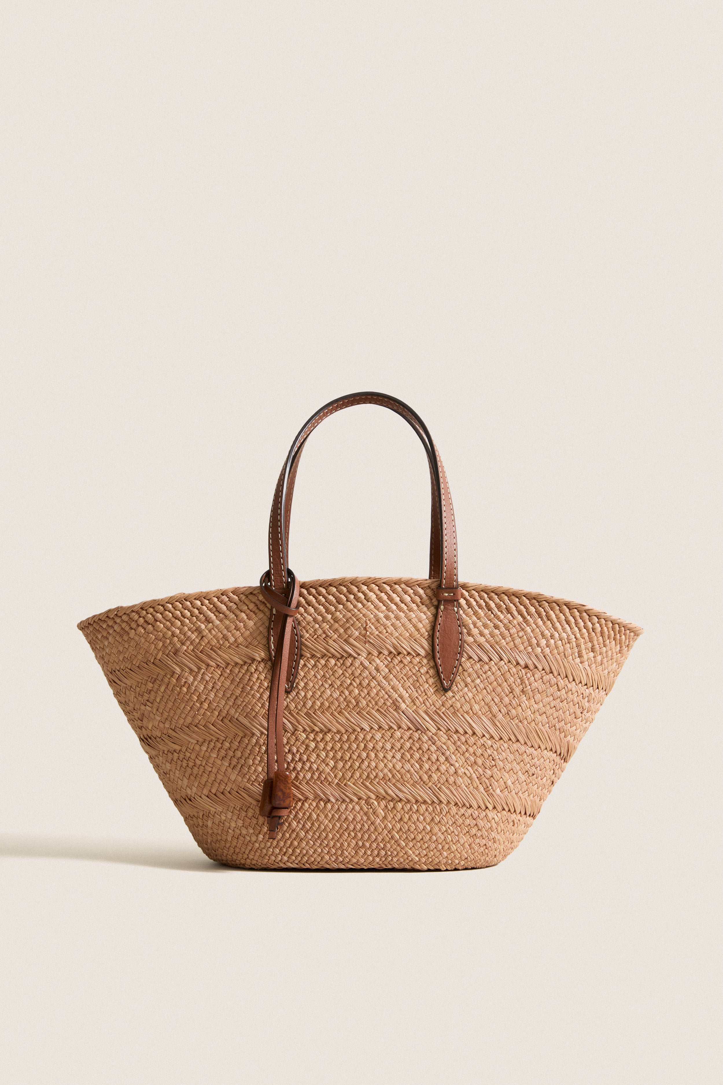Nuez and Cognac Small Trapeze Basket, classic woven straw tote featuring effortless leather handles and tie, perfect for fun, high-end style with handwoven craftsmanship.