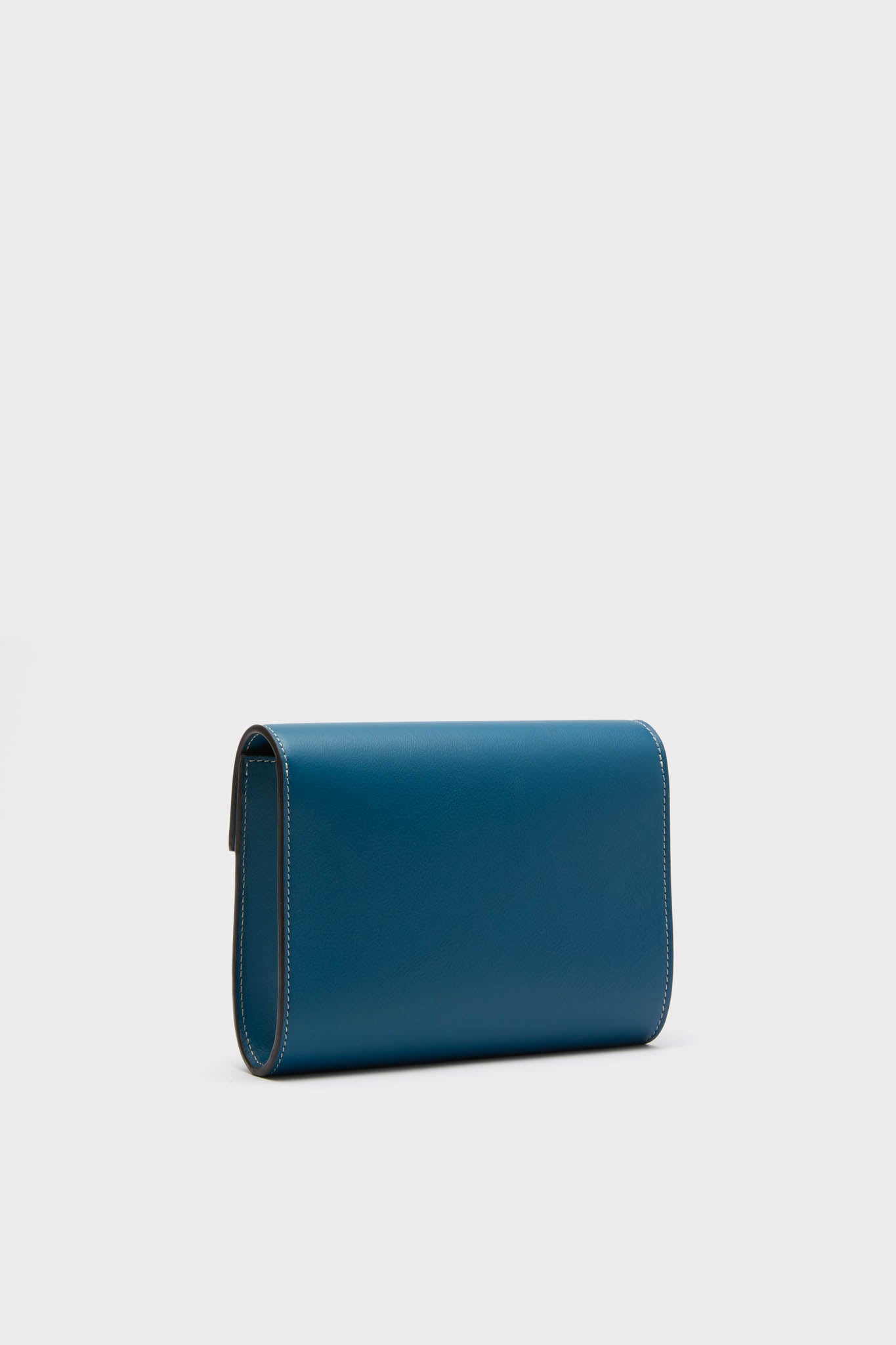 Classic Teal Small Soft Clutch in teal-blue leather with clean lines and contrast stitching. Features a fold-over flap and slip-through closure, exuding an effortless, high-end appeal.