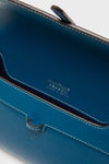 Teal Small Soft Clutch with white topstitching and gold-foil HUNTING SEASON – MADE IN SPAIN stamp, showcasing its classic, effortless, and high-end craftsmanship.