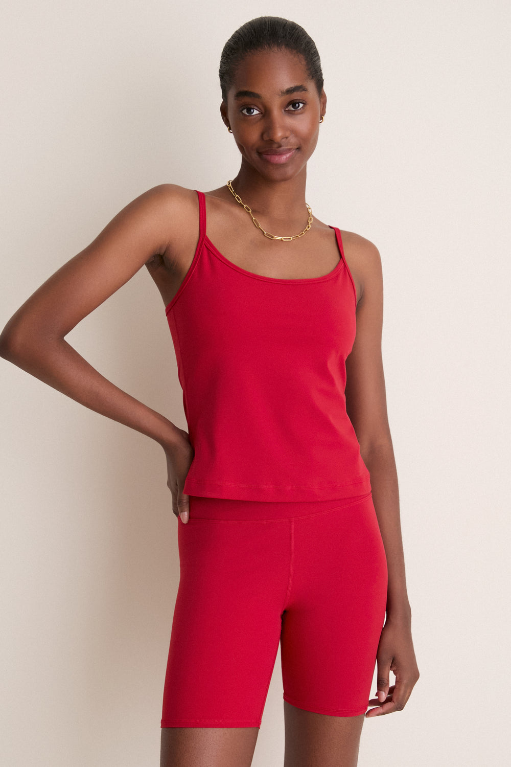 Young woman wears the classic, high-end Red Compression Spandex Sofia Cami, featuring a sleek design with adjustable straps and a built-in shelf bra for effortless style and comfort.