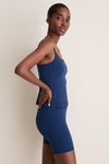 Young woman in profile wears the classic, high-end Navy Compression Spandex Sofia Cami, showcasing its effortless style and functional design with adjustable straps and a built-in shelf bra.