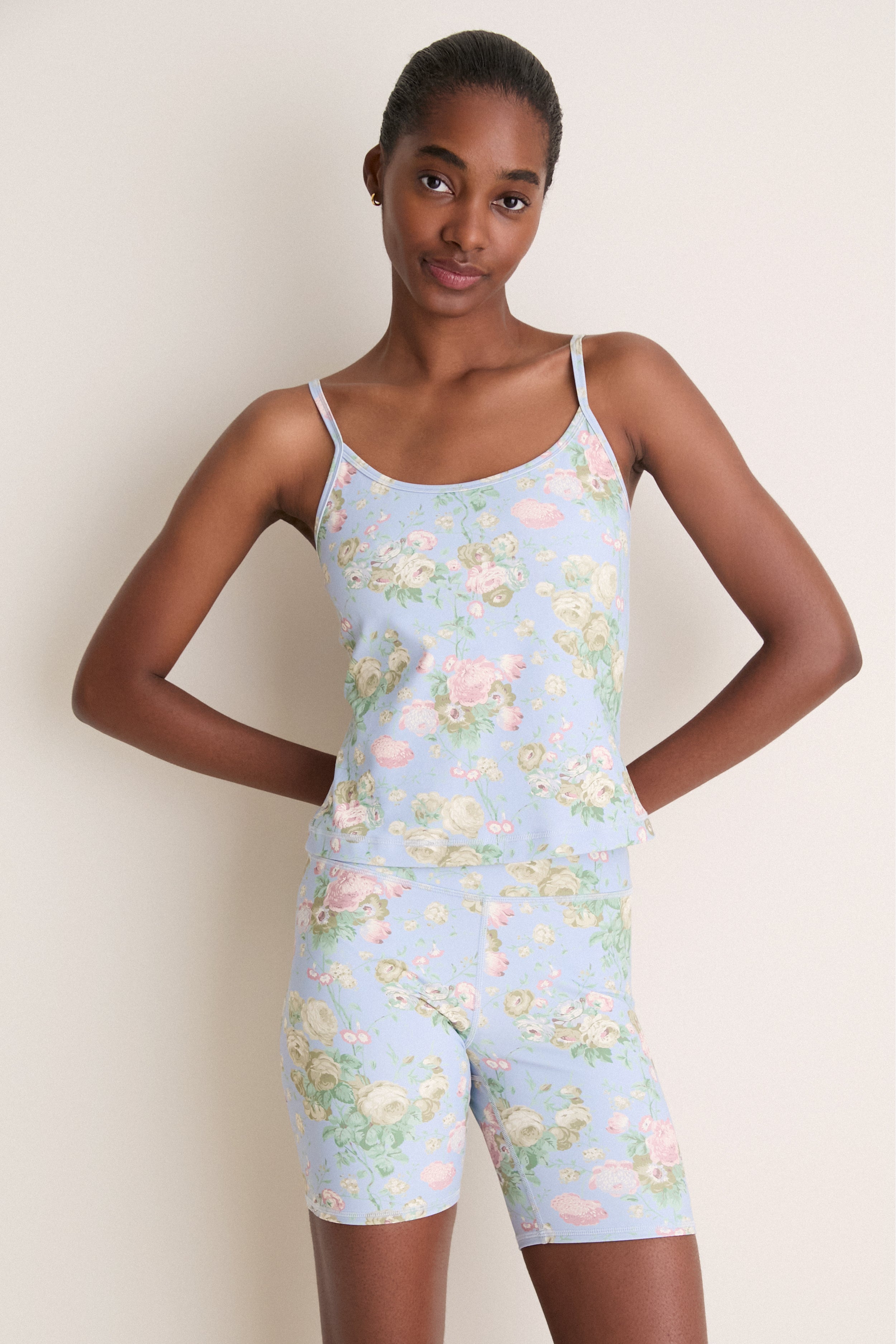 Young woman models the Clubhouse Chintz Compression Spandex Sofia Cami, showcasing its classic, effortless fit with adjustable straps and built-in shelf bra for a high-end, fun style.