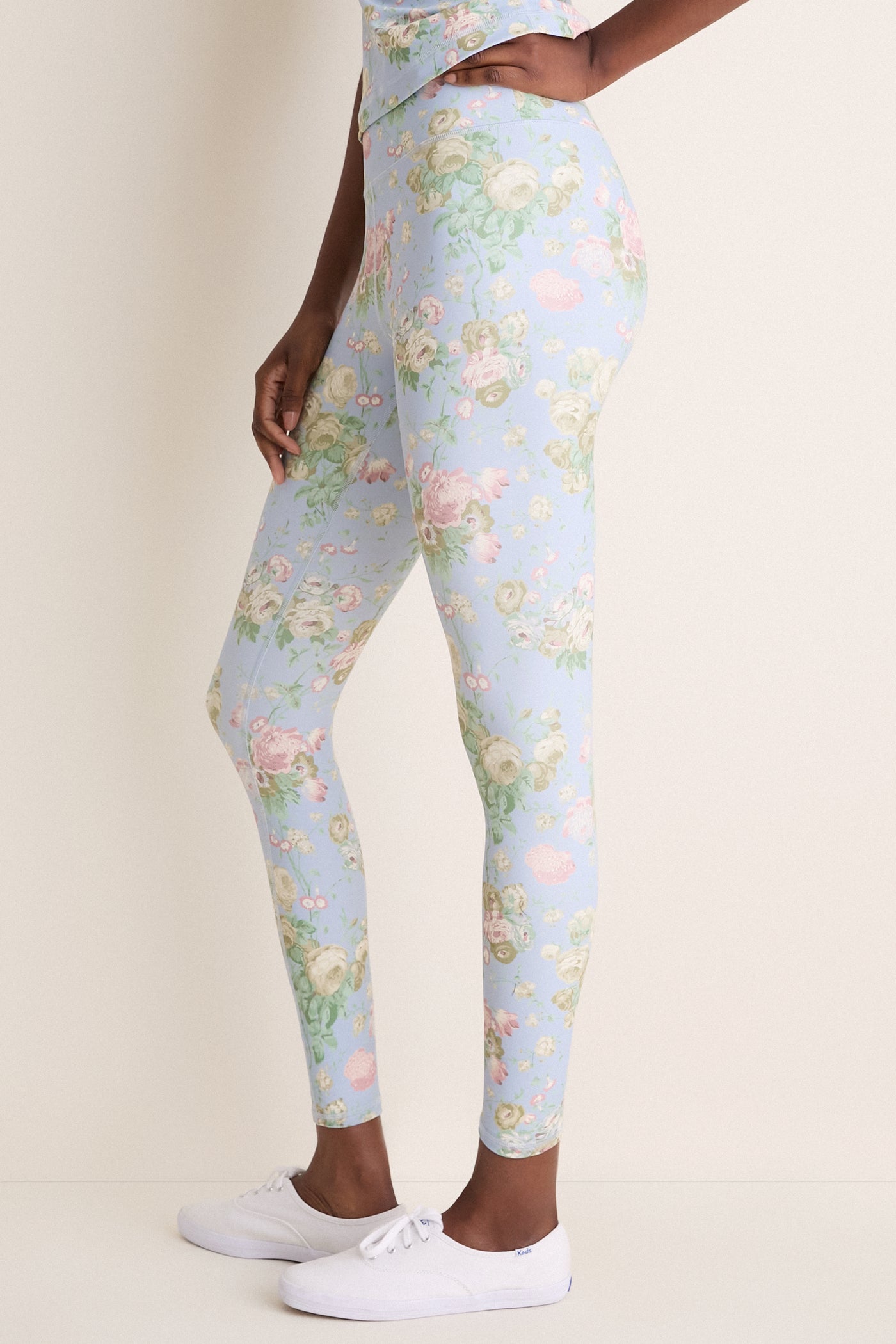 Clubhouse Chintz High Rise Compression Spandex MacKenzie Legging in sky-blue with floral print, paired with white Keds sneakers, embodies classic, effortless style and fun.