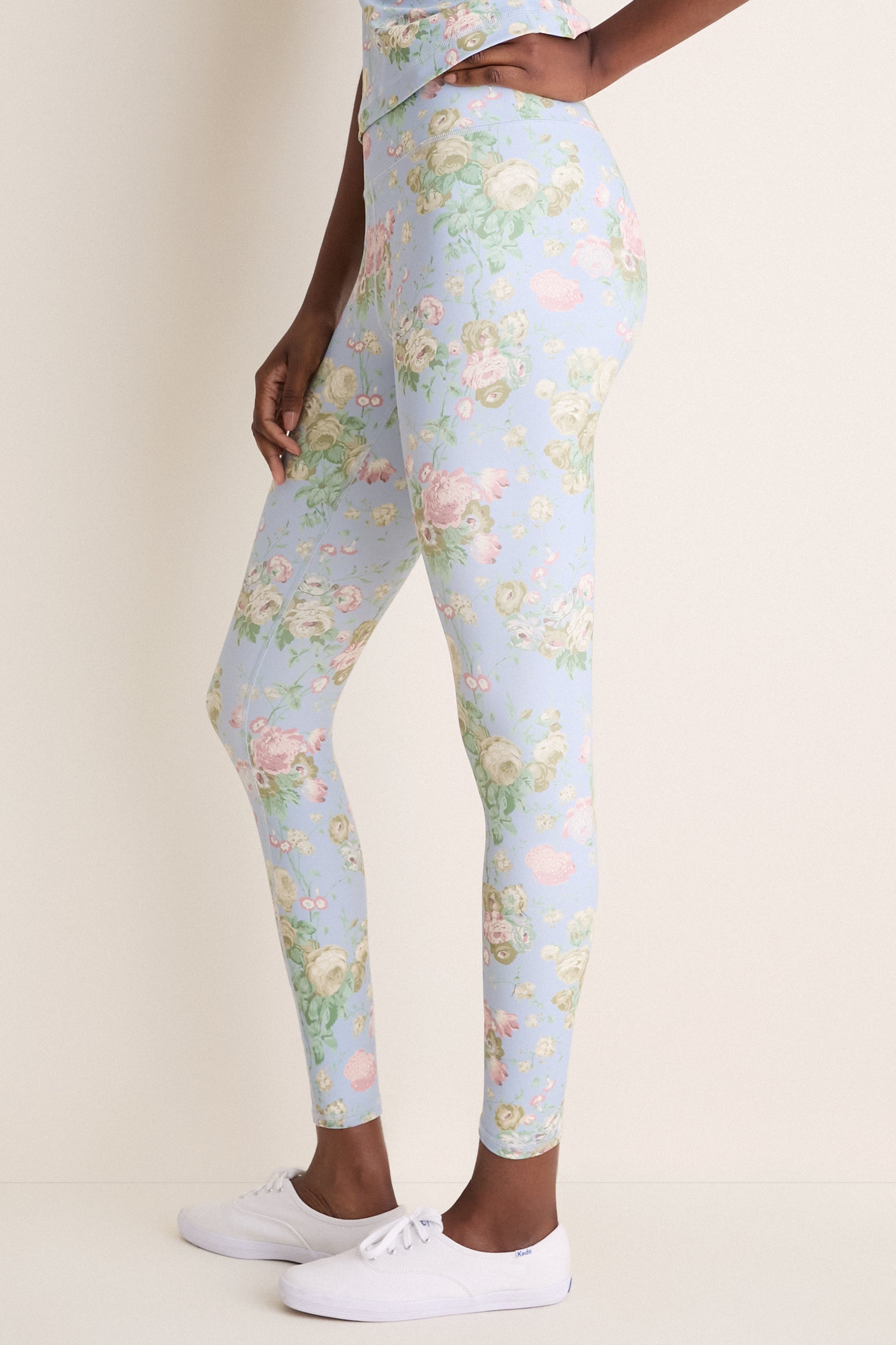 Clubhouse Chintz High Rise Compression Spandex MacKenzie Legging in sky-blue with floral print, paired with white Keds sneakers, embodies classic, effortless style and fun.
