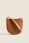 Classic Cognac Leather Nigeria Crossbody with gold-tone hardware and adjustable strap, exuding effortless elegance and high-end craftsmanship, perfect for fun, versatile styling.