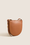 Classic Cognac Leather Nigeria Crossbody, a high-end, effortless saddle-bag style with gold-tone studs and slim strap, perfect for fun, versatile day-to-night wear.