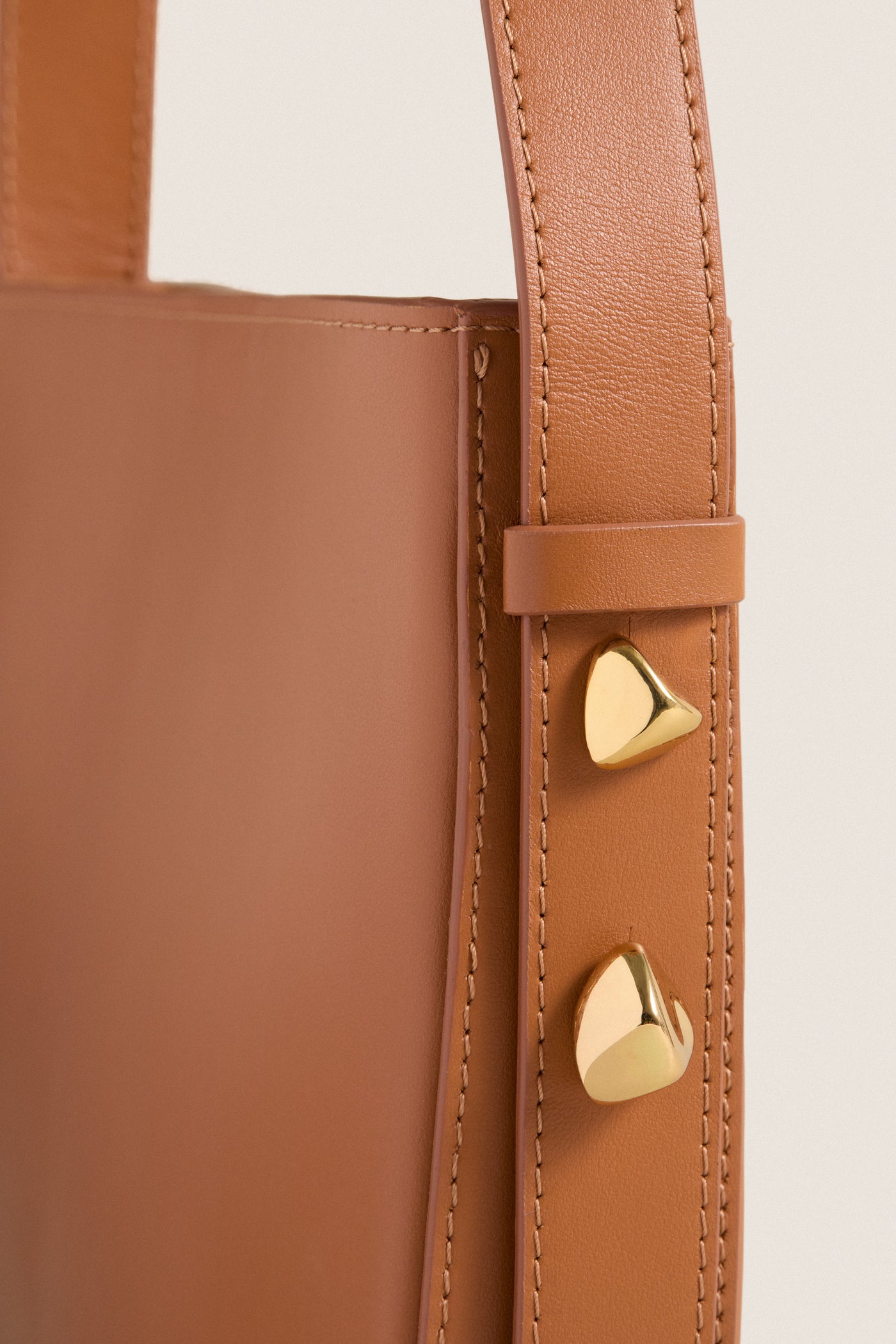 Classic Cognac Leather Nigeria Crossbody featuring elegant stitching and gold-tone hardware, exudes an effortless, high-end style, perfect for fun day-to-night transitions.
