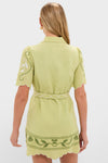 Woman in a Pastel Mint Poppy Mini Dress with scalloped sleeves and floral embroidery, exuding classic, effortless style for high-end, fun everyday wear.