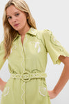 Model wearing the Pastel Mint Poppy Mini Dress: a classic, effortless shirtdress with scalloped sleeves and embroidered motifs, embodying high-end, fun style.