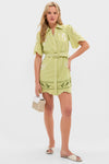 Pastel Mint Poppy Mini Dress: A classic, high-end shirt-dress with scalloped edges, effortless button-front closure, and fun embroidered motifs, styled with a wicker purse and white sandals.