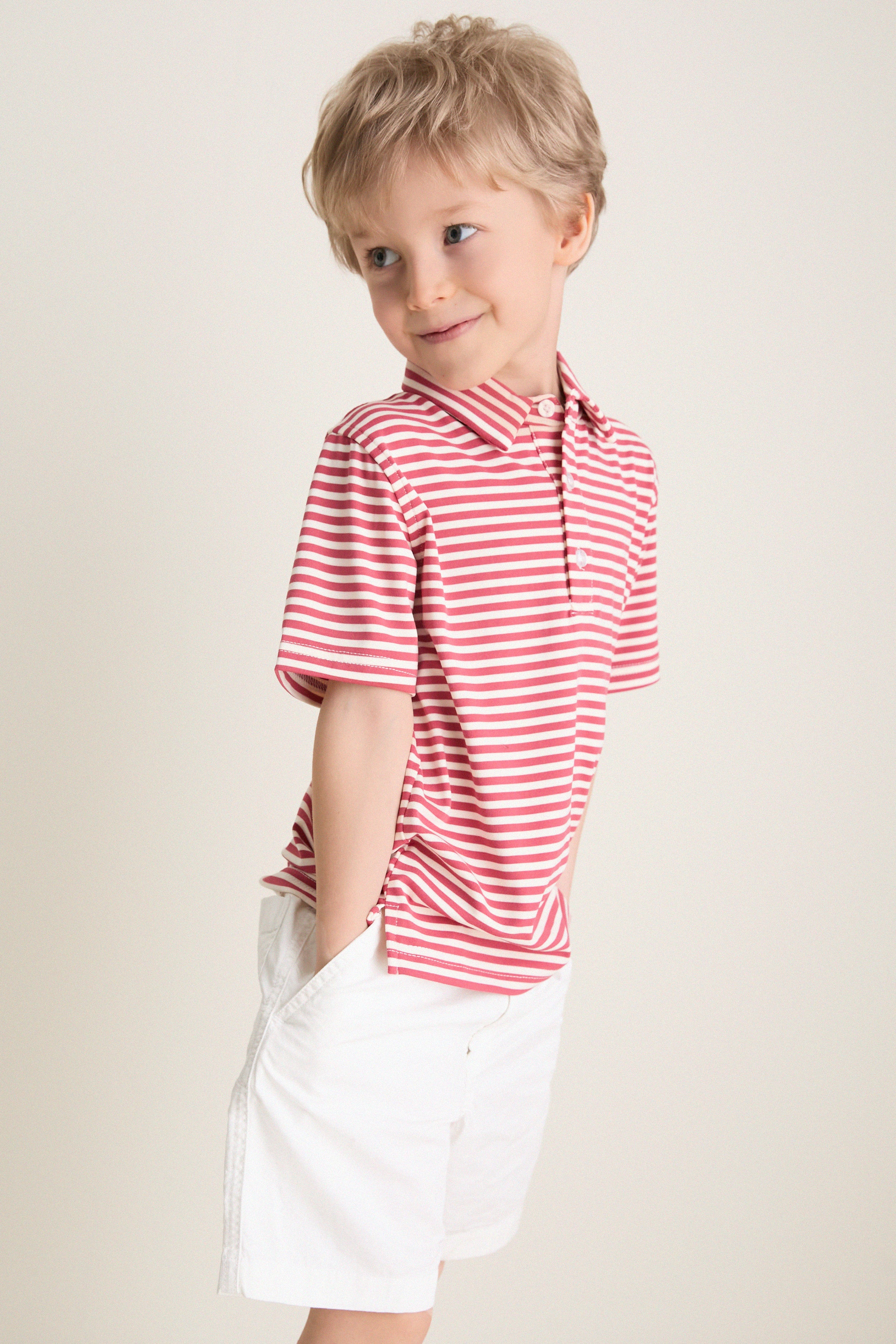 Preschool child in a classic, effortless Nantucket Red and Creme Le Club Polo, hands in pockets, embodying fun and high-end style with discrete back embroidery.