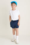 Young boy in classic, effortless Before Sunrise Blue Cardio Short, showcasing fun, high-end style with elastic waistband and pockets, embodying Tuckernuck's cool, ready-for-anything spirit.
