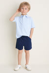 Young boy models Nautical Navy Le Club Short, embodying a classic, effortless style with fun, high-end comfort, perfect for active, warm-weather adventures.