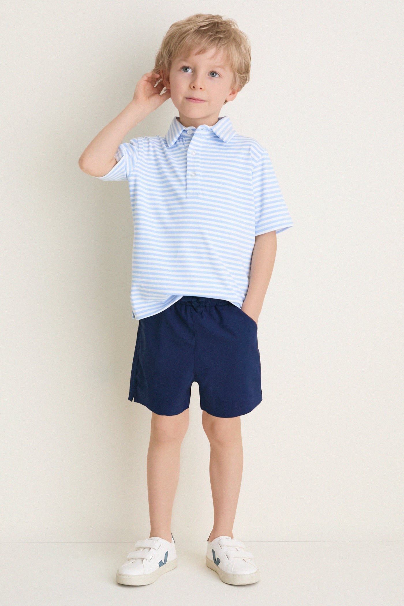 Young boy models Nautical Navy Le Club Short, embodying a classic, effortless style with fun, high-end comfort, perfect for active, warm-weather adventures.