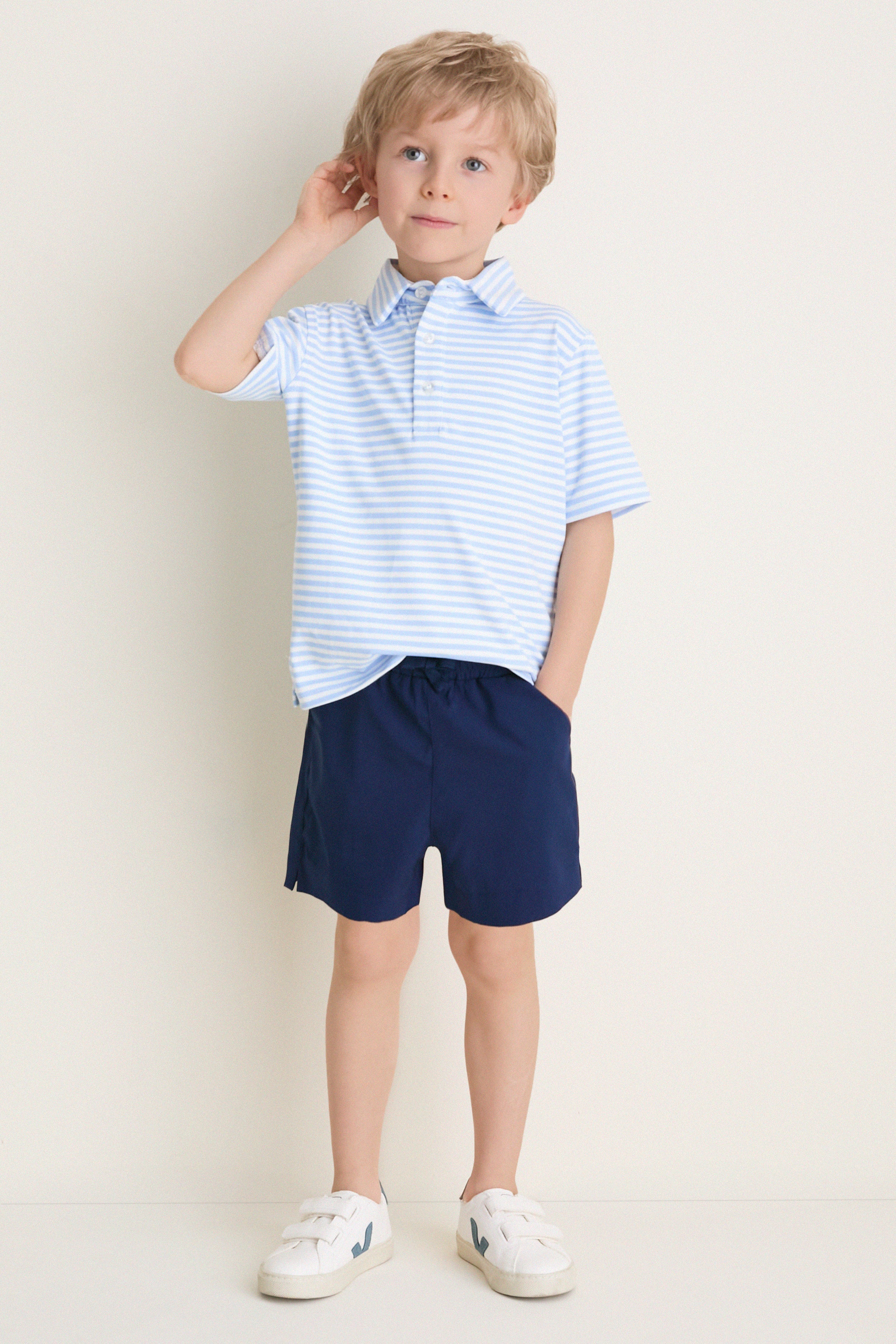 Young boy models Nautical Navy Le Club Short, embodying a classic, effortless style with fun, high-end comfort, perfect for active, warm-weather adventures.