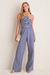 Ocean Gingham Kat Jumpsuit on model; effortless, classic style with sweetheart neckline, oversized bow, high-waisted trousers, and multi-strand necklace for a fun, high-end look.