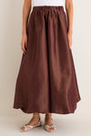 Classic and effortless, the Chestnut Taffeta Cynthia Bubble Skirt features a fun, high-end bubble hem and elastic waistband, styled with woven sandals for a chic look.