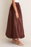 Classic and effortless, the Chestnut Taffeta Cynthia Bubble Skirt features a fun bubble hem and elastic waistband, paired with high-end beige braided-strap sandals.