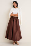 Young woman in a classic, effortless style wearing the Chestnut Taffeta Cynthia Bubble Skirt with its flirty bubble hem and elastic waistband, showcasing high-end, fun elegance.