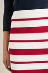 Person wearing the classic Ruby Knit Stripe Milo Pencil Skirt, showcasing bold, horizontal red and white stripes with a ribbed waistband, embodying effortless style and high-end flair.