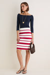 Woman in Ruby Knit Stripe Milo Pencil Skirt, high-waisted with bold stripes, embodying a classic yet fun and effortless high-end style.
