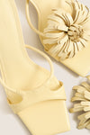 Buttercream Alora Low Heel: Classic square-toe sandals with an effortless, fun floral appliqué. High-end leather design with sculptural heel, perfect for versatile style.