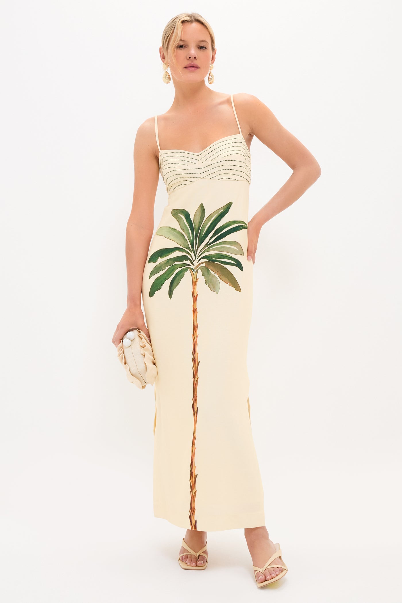 A young woman models a classic slip dress, showcasing Light Natural Brevel Heels for an effortless, high-end look, complete with fun accessories.