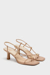 Light Tan Mylee Heels: Classic, high-end heeled sandals with an effortless, fun design featuring crisscrossing straps, gold-tone bead accents, and a mid-height block heel.