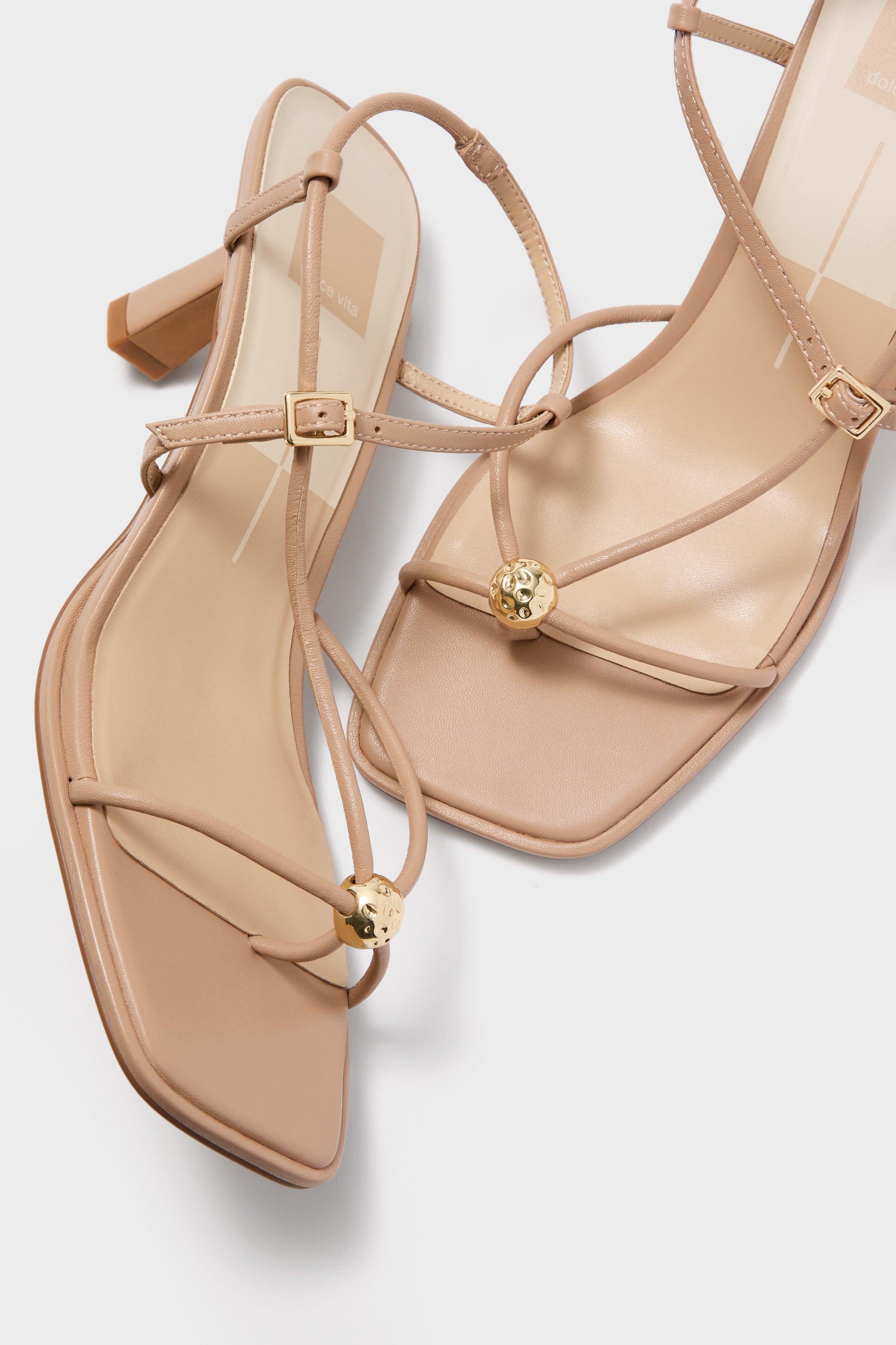 Light Tan Mylee Heels: Classic nude leather strappy sandals with square toes, low block heels, and elegant gold accents for an effortless, high-end look.