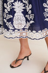 Blue and White Richilieu Midi Dress with intricate embroidered hem, styled with black strappy heels, embodies classic, effortless elegance and high-end fun for any occasion.